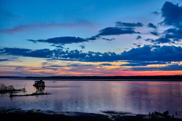  As the red sun sinks into the horizon, the Amazon River glows like liquid fire. Out here in the wilds of Peru, every sunset feels like the start of a new expedition 