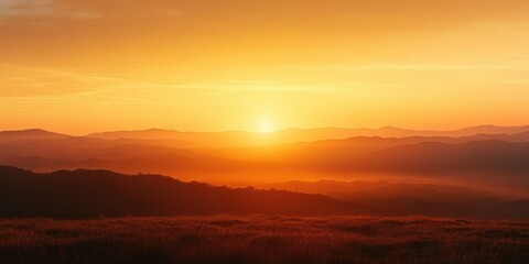 Wall Mural - Vibrant orange sunrise over rolling hills and distant mountain ranges with a peaceful and warm atmosphere