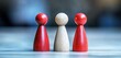 © Worrapol - Three Colorful Wooden Figurines in Red and Natural Finish Representing Diversity and Inclusion on a Soft Focus Background