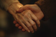 © saira - A photograph of two hands holding each other, showing care and support