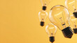 © 阿咩hu - Floating light bulbs in warm glow, symbolizing creative ideas and innovation in a minimalist setting
