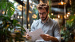 © ganlaya - a young professional reviewing documents at a co-working space