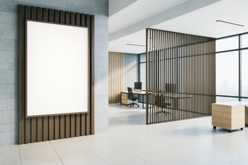 Poster - Blank vertical poster on modern office wall with wooden slats and open workspace in background under bright interior lighting conditions.