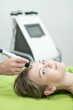 © Михаил Решетников - Caucasian woman undergoing radio wave RF lifting procedure in beauty salon.