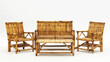 © Sai Tunyee - Bamboo furniture, including  comfortable sofa, wooden table, wicker armchair, and plant filled decor.