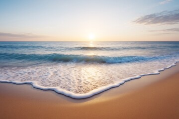 Poster - Serene sunrise over gentle ocean waves washing onto sandy beach, soft lighting creates peaceful seascape background for travel or creative use.