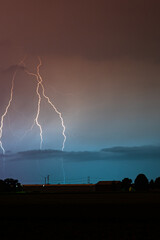Wall Mural - dramatic image of three lightning bolts next to each other