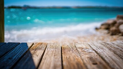 Poster - Close-up of weathered wooden beach dock overlooking turquoise ocean with sandy shore