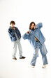 © Bliss - Stylish young couple expressing love and joy in trendy denim outfits against a minimalist backdrop