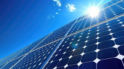 Close up of a large array of solar panels against a bright blue sky.