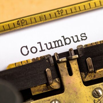 Vintage typewriter typing columbus on paper with close-up view