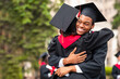 © Prostock-studio - Cheerful black guy hugging his girlfriend while graduation ceremony at university campus. Happy african american students greeting each other with successful graduation, closeup