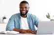 © Prostock-studio - Portrait Of Smiling Successful African American Male Entrepreneur Posing At Workplace In Modern Office, Handsome Black Man Sitting At Desk With Laptop Computer And Looking At Camera, Copy Space