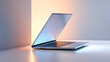 © RF GRAPHIC - Modern silver laptop displayed on white surface with soft warm and cool lighting