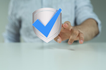 Poster - Hand holding a digital shield with a checkmark.  Data security and protection concept.