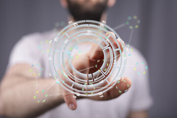 Poster - A person uses a futuristic interface to view and analyze data, represented as a holographic circular chart.
