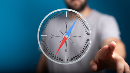 Aufkleber - Stock photo of a man interacting with a digital compass, symbolizing guidance and direction.