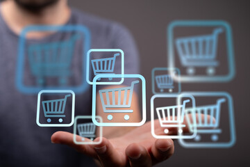 Aufkleber - Hand holding multiple shopping cart icons, symbolizing online shopping and e-commerce.