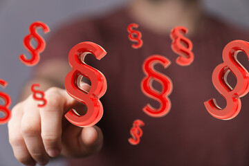 Poster - Abstract image of a hand interacting with floating 3D paragraph symbols, ideal for legal or law-related concepts.