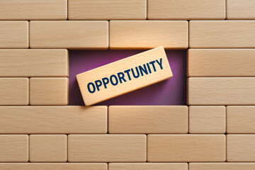 Poster - The concept opportunity emerges as a key element breaking through a structured wall wooden blocks symbolizing breakthrough and potential in business growth