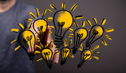 Poster - Hand interacting with glowing lightbulbs, symbolizing innovation and creativity.