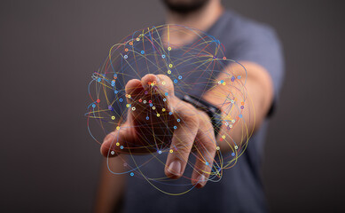 Poster - A man's finger interacts with a vibrant, interconnected digital network, representing global connectivity and data flow.