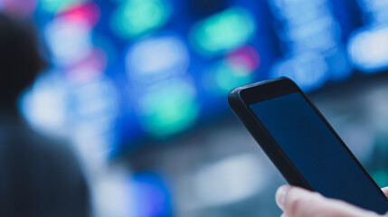 Poster - Smartphone's Gaze at Stock Market: A person's hand securely holds a modern smartphone. with its screen reflecting the fluctuations of a vibrant stock market, signifying real-time financial engagement.