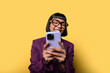 © ADDICTIVE STOCK - Hispanic woman smiling while using her smartphone