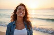 © miss irine - Beautiful latin woman smiles at beach at sunset. Portrait of happy smiling young girl enjoying vacation at sea shore. Calm, carefree, positive emotions of vacationer feeling joy, freedom and relax.