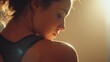 © Justlight - Cinematic close up of a young sportswoman relaxing after an intense workout, her face and shoulder illuminated by warm light, conveying a sense of accomplishment and tranquility