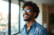 © miss irine - Cheerful young African American man in glasses poses in own apartment. Close-up headshot portrait of happy millennial male renter, tenant shows optimism.