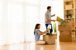 © BGStock72 - Couple unpacks boxes together in bright living room, creating a cozy new home full of warmth and excitement during the afternoon