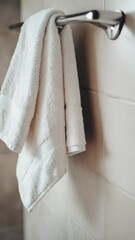 Poster - Close-up shot of a towel hanging on a towel rack, simple home decor