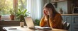 © Pete - Woman at home office takes break from laptop work. Stressed female touches head. Tired, thoughtful young woman sits at desk, looks at screen, has a hard day.