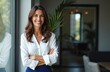 © Pete - Smiling business woman, 40s. Confident manager at office window, arms crossed. Attractive female executive, happy, looking camera. Portrait of successful entrepreneur. Professional lady, work.