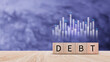 © rawintanpin - Debt growth for debt reduction concept, growth of public debt on wooden cube, Delve deeper the complex concept of debt and significant impact on effectively managing personal finances.