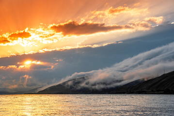 Wall Mural - Beautiful sunset with clouds over the lake.