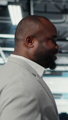 Poster - vertical video happy businessman walking in data center, assessing rackmounts capacity before invest