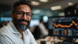© xuxu - Man stock trader smiling at his desk with blurred financial charts on monitors in the background, business finance footage.