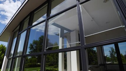 Aufkleber - Sleek window elegance with modern glass architecture exterior, blue sky reflection, green landscape, contemporary home design