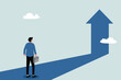 © NASIH - Business success concept to the next level. Businessman standing in front of an arrow symbol pointing up