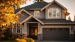 © Open - Blurry image of large gray house framed with fall foliage at golden hour