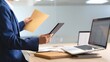 © UrFreepik360 - Businesswoman reviewing documents and using digital tablet in modern office setting