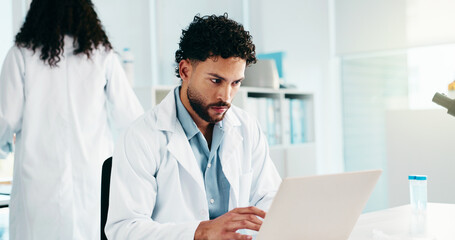 Fototapete - Serious, man and scientist on laptop in lab for research, reading study and medical experiment. Male person, typing and online for project, biotechnology or science article for healthcare information