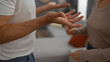 © Krakenimages.com - Couple having a discussion in a cozy living room setting, expressing emotions through gestures, capturing real-life relationship dynamics