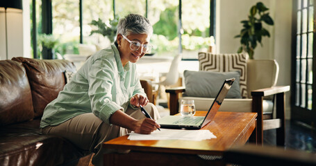 Poster - Mature woman, remote work and writing on document for finance, budget review and asset management. Laptop, freelancer and happy person with paper in living room for accounting or tax return in home