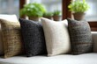 © Iryna Bondariuk - A close-up shot showcases a set of stylish decorative pillows on a modern sofa, arranged against a blurred background, creating a cozy and inviting atmosphere in the room.
