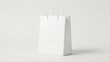 © insane - A blank white shopping bag with twisted paper handles, perfect for branding and retail use.