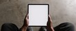 © Ol - The tablet held by a person in a minimalist workspace setting.