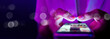 © Urupong - Finger of woman touching scroll page app on mobile phone.In a room with blue and purple neon tones.concept Social media and marketing